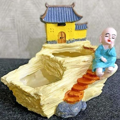 alt="blissful monk by temple"